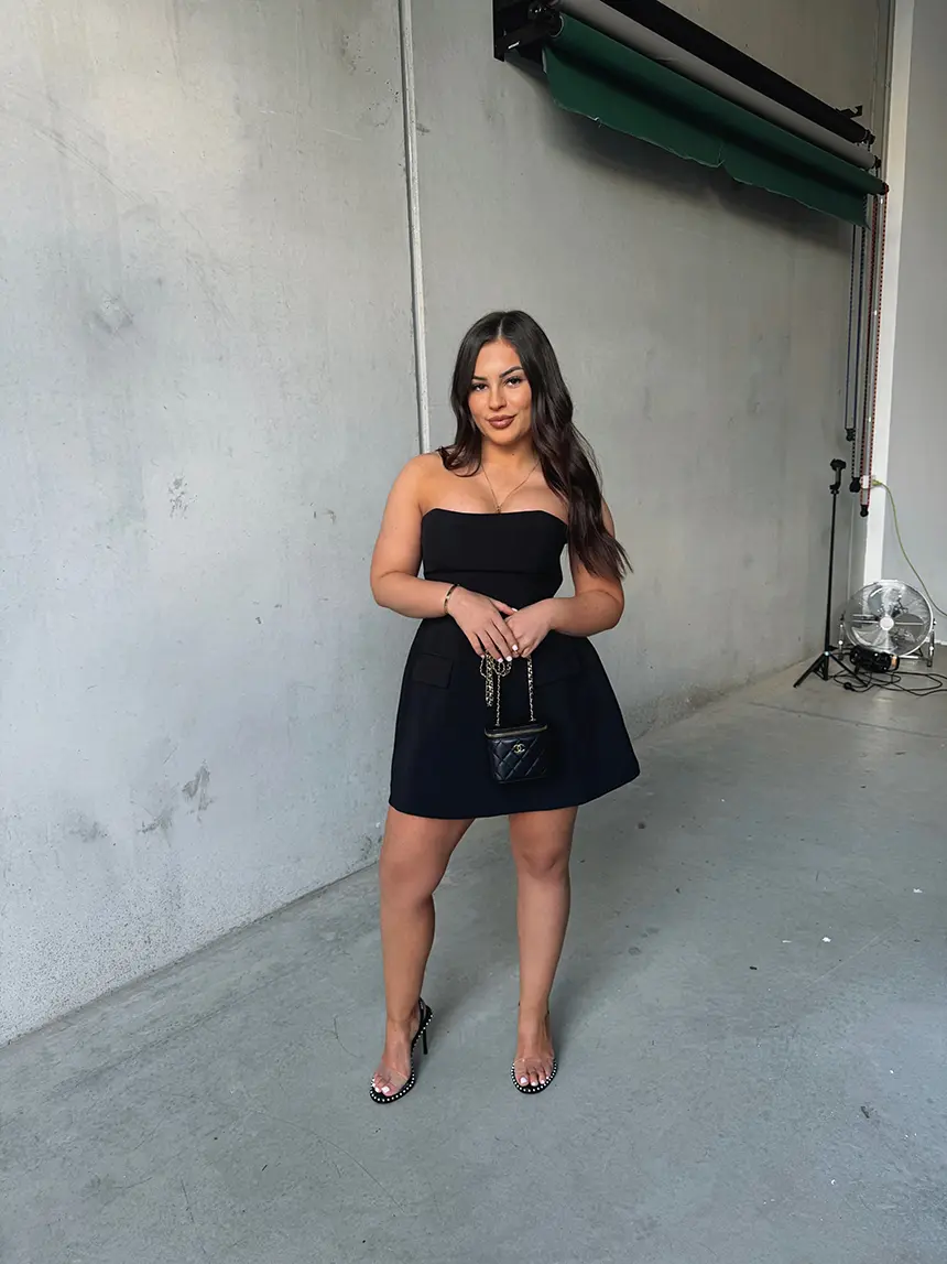 Urban Hires founder wearing a black occasion dress